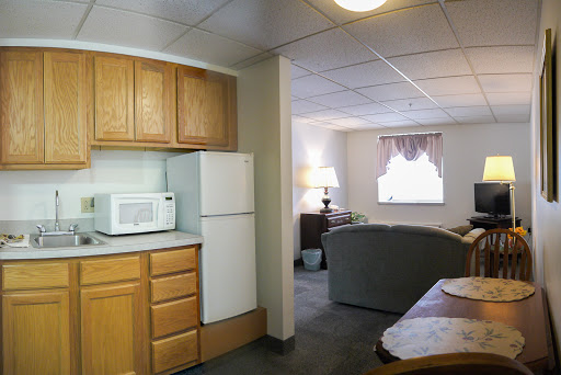 A cozy apartment featuring a small kitchen and a living area.