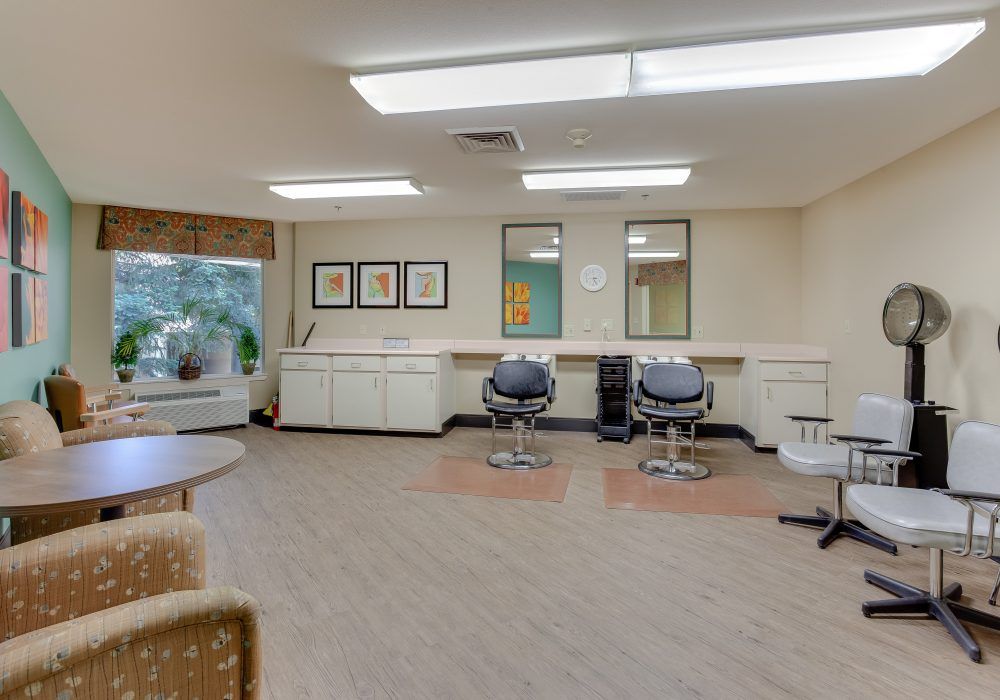 A modern hair salon with styling chairs and mirrors.