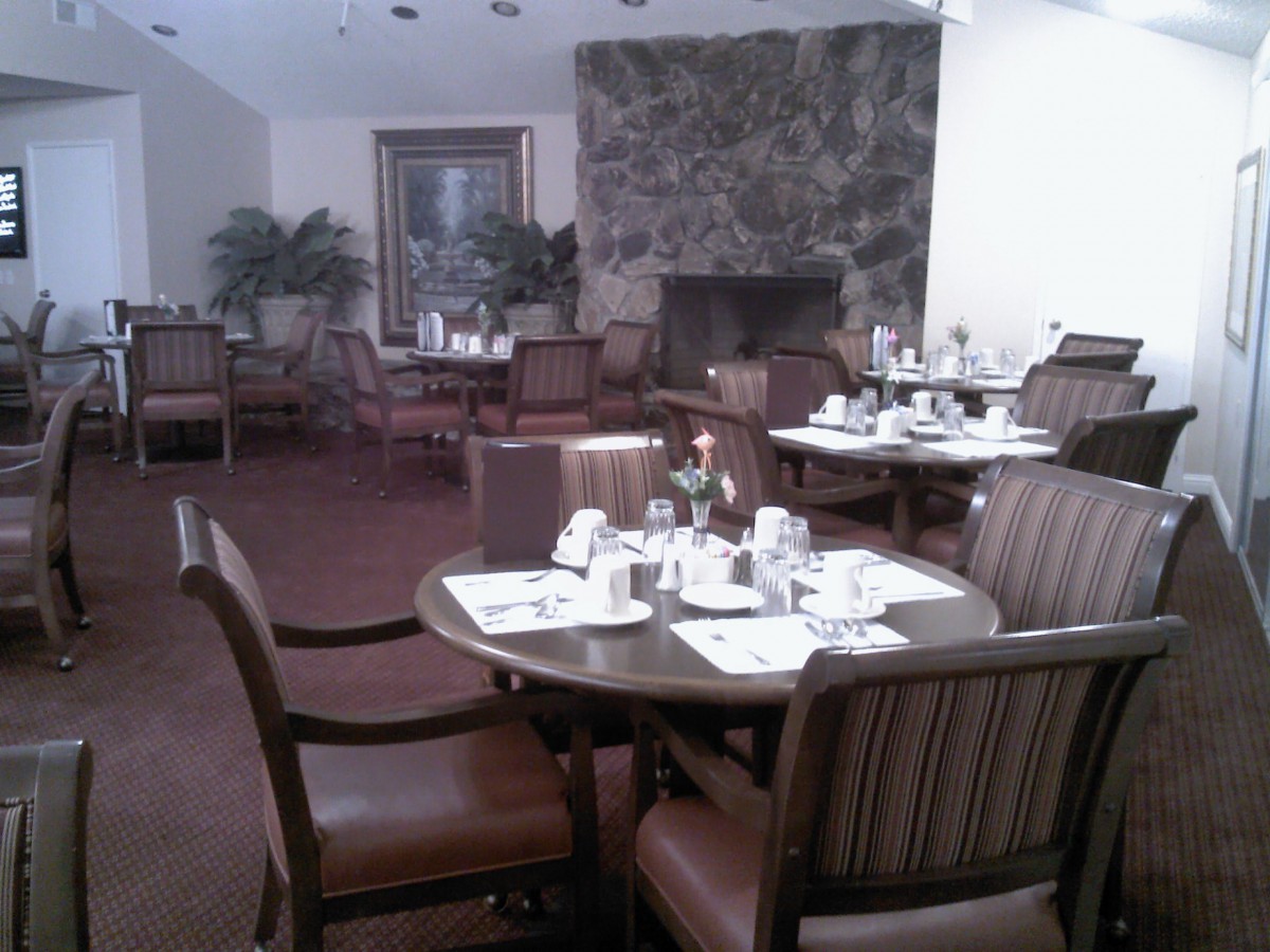 An elegant indoor dining area with set tables and comfortable seating.