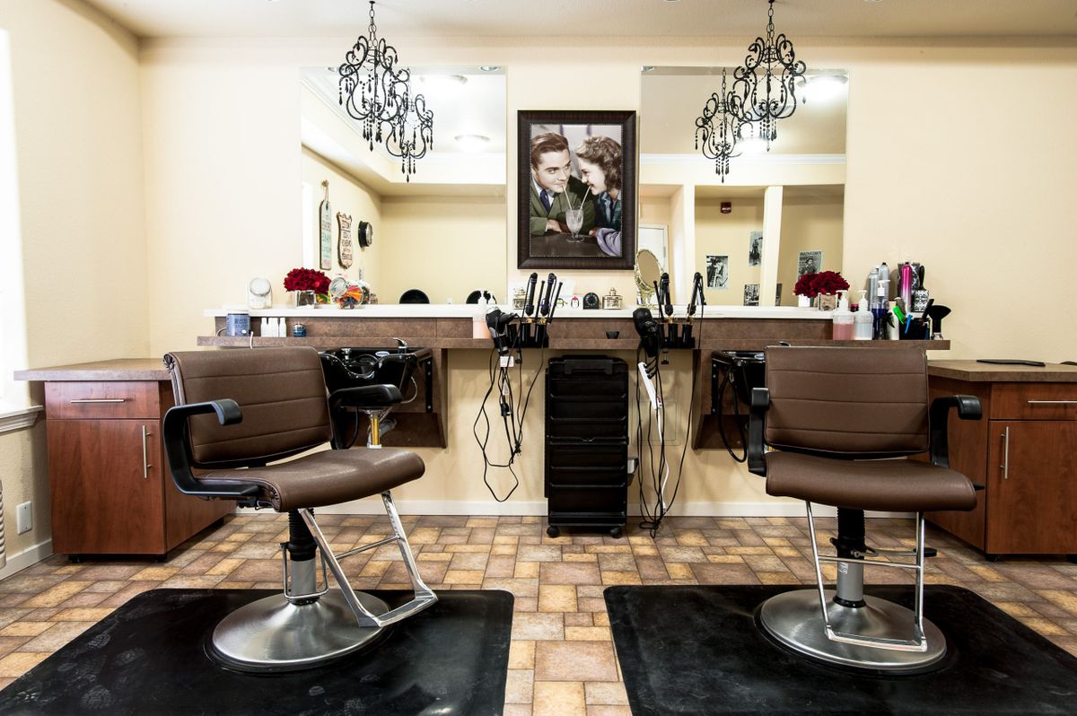 Chic hair salon interior with styling stations and elegant lighting.