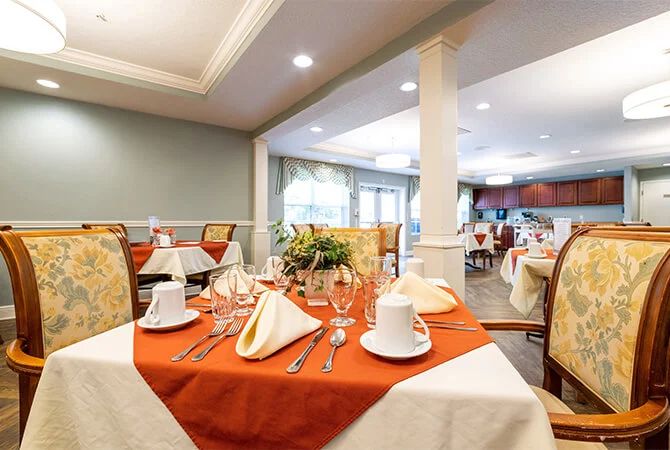 An elegantly set dining area with neatly arranged tables and stylish dcor.