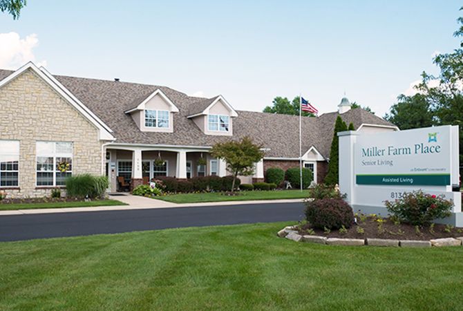 A well-maintained building with a neatly landscaped lawn and a sign out front.