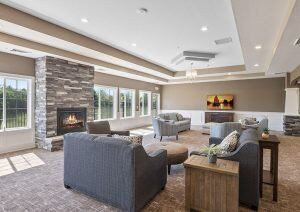 A modern living room with comfortable sofas, a fireplace, and large windows.