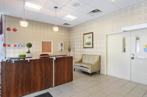 A well-designed reception area featuring a stylish desk, comfortable seating, and decorative elements.