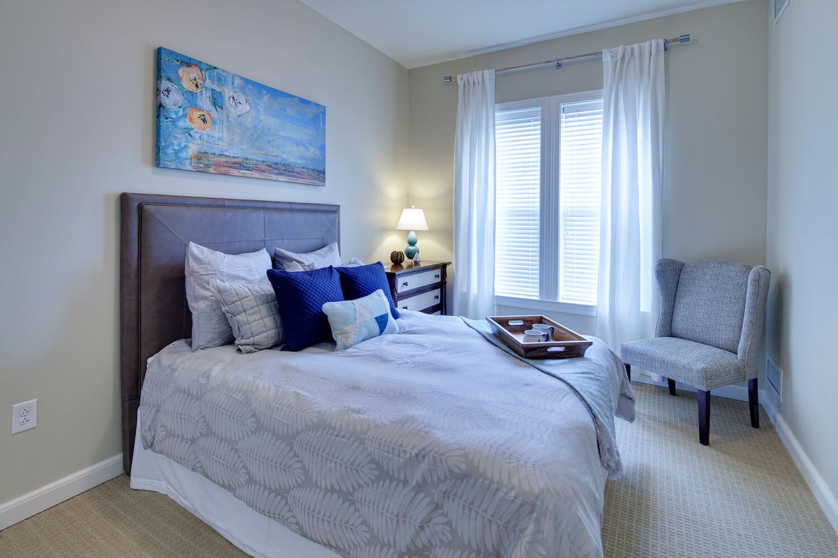 A modern, cozy bedroom with stylish decor and natural light streaming through the windows.