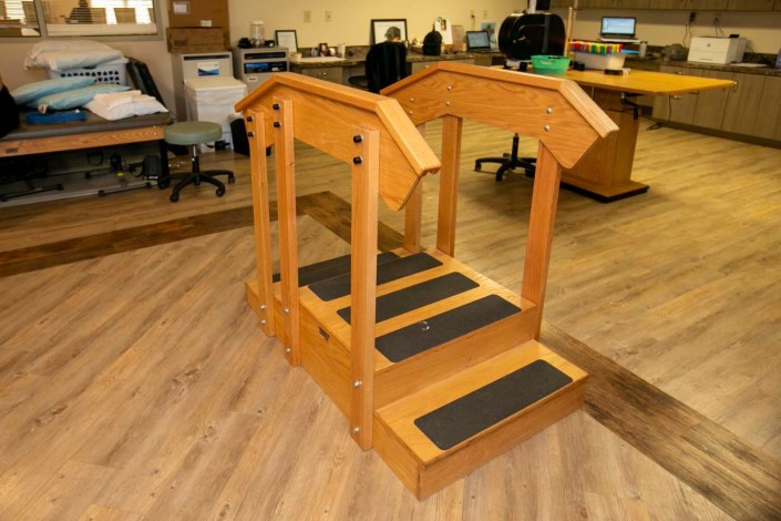 This image shows a wooden stair training tool used in physical therapy for rehabilitation exercises.