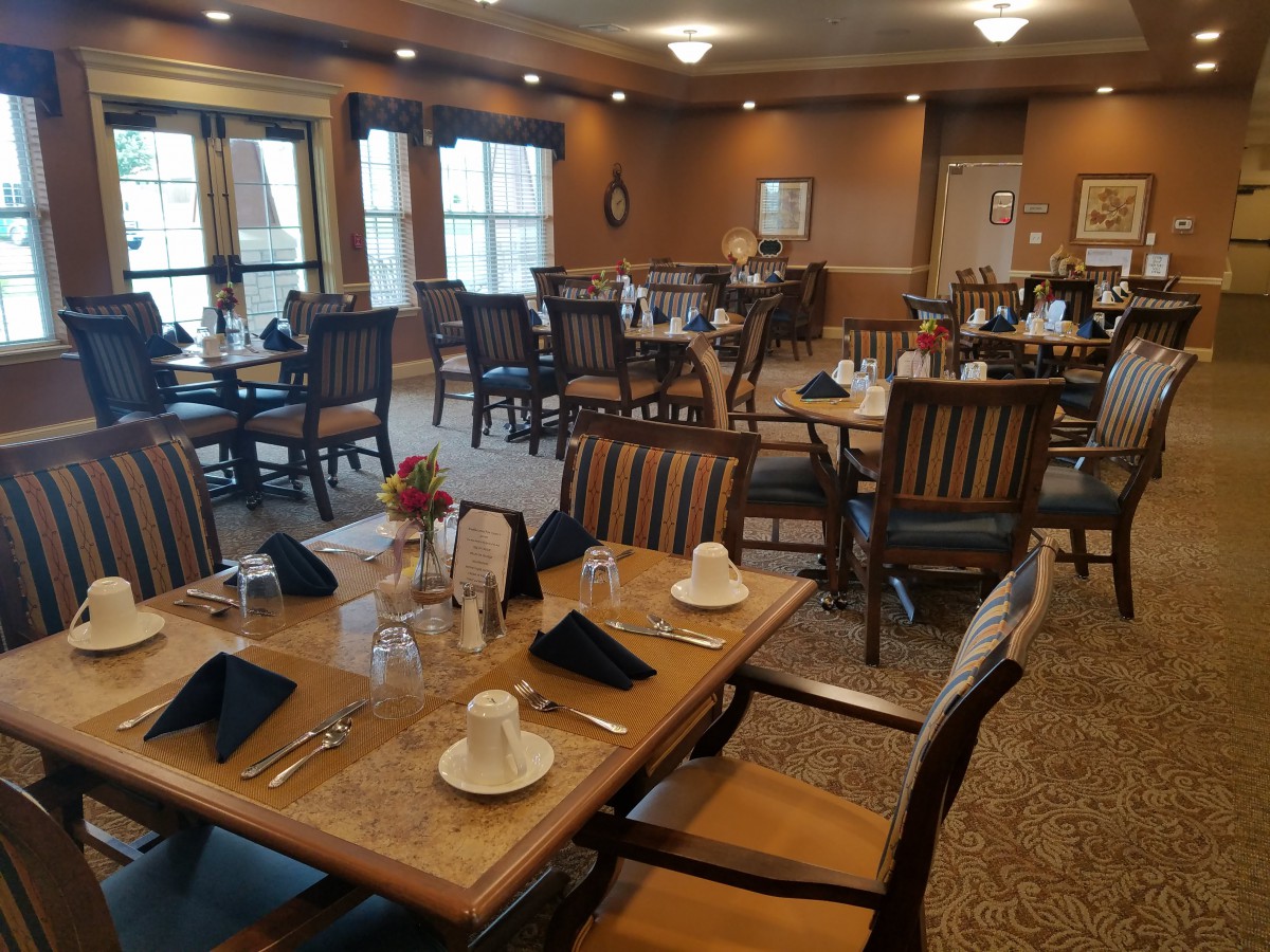 An elegant dining room with neatly arranged tables and chairs, ready for guests.