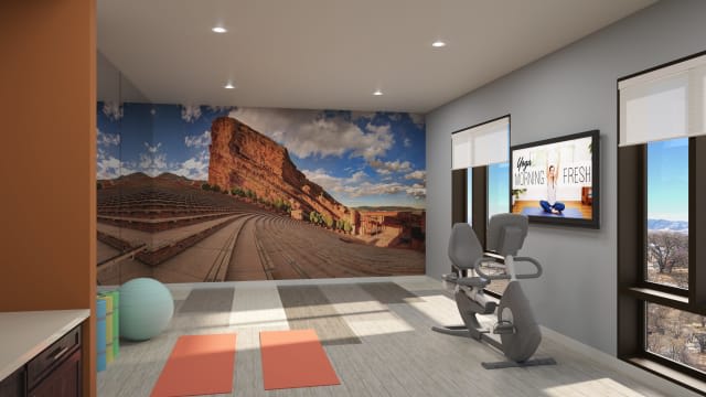 A modern home gym featuring exercise equipment, yoga mats, and a scenic mural on the wall.