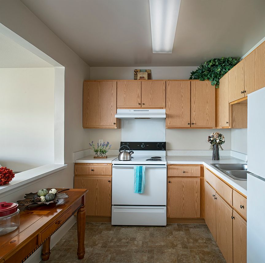 A cozy kitchen with wooden cabinets and modern appliances.