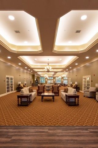 A spacious and elegantly designed lounge with comfortable seating and ambient lighting.