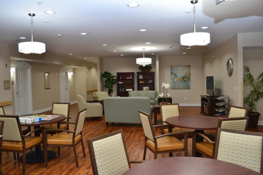A spacious lounge area with comfortable seating and wooden floors.