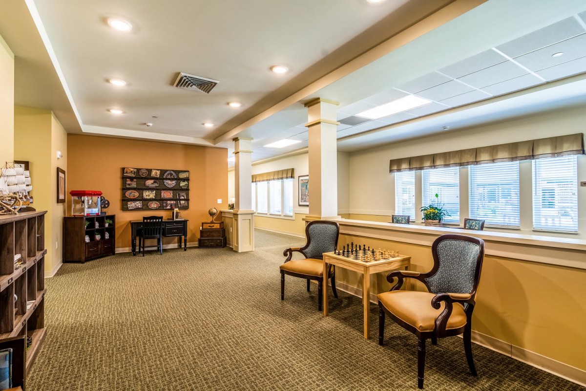 A well-lit lobby area with chairs and a carpeted floor.