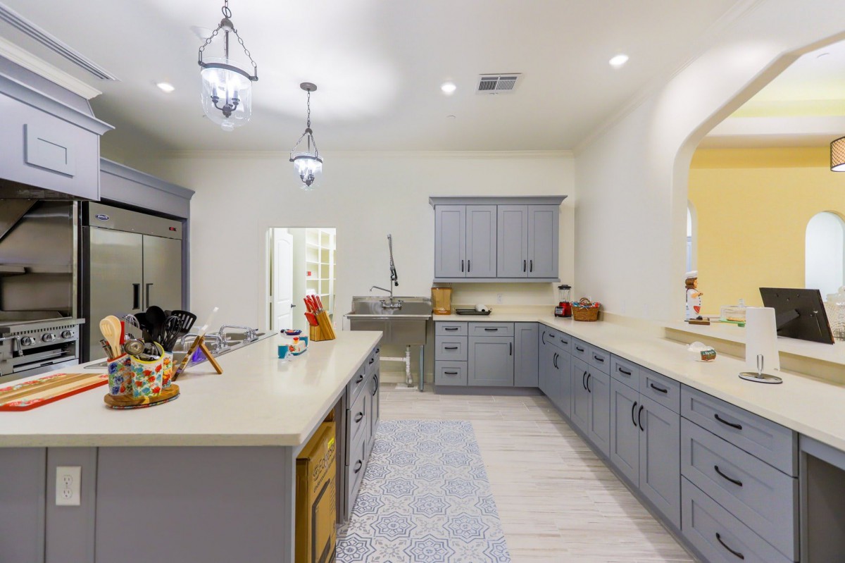 A modern kitchen with gray cabinets and sleek countertops.