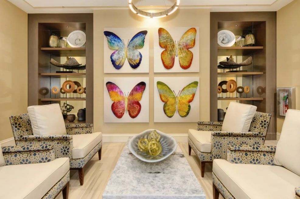 A modern living room featuring colorful butterfly artwork and elegant decor.