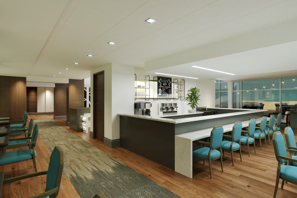 A modern office interior with a conference area and kitchen space.