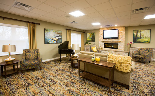 A cozy living room featuring a piano, comfortable seating, and stylish decor.