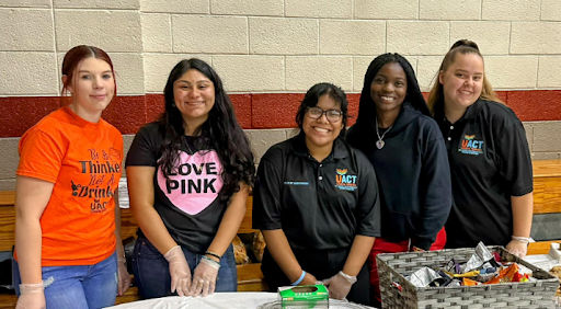 A group of enthusiastic volunteers posing together at a community event.