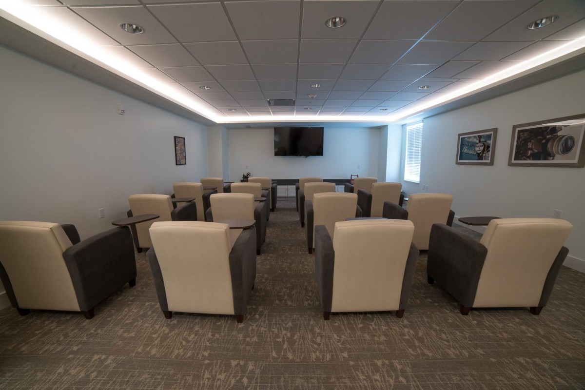An indoor conference room with arranged seating and a television for presentations.