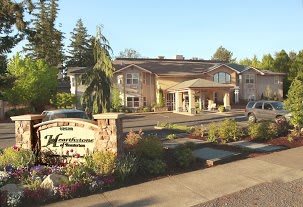 A well-maintained building with a landscaped garden at its entrance.