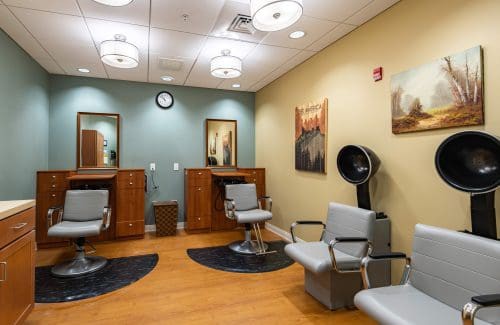 Interior of a modern barber shop with chairs and styling stations.