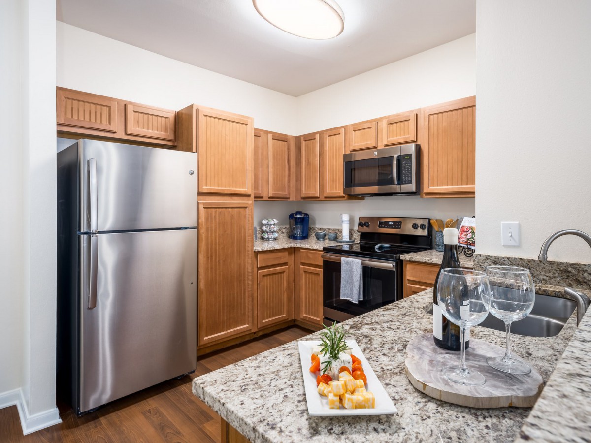 A modern kitchen with stainless steel appliances and granite countertops.