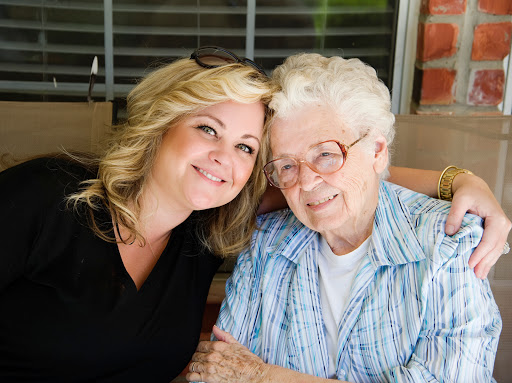 A joyful moment captured between a grandmother and her granddaughter, sharing smiles and love.