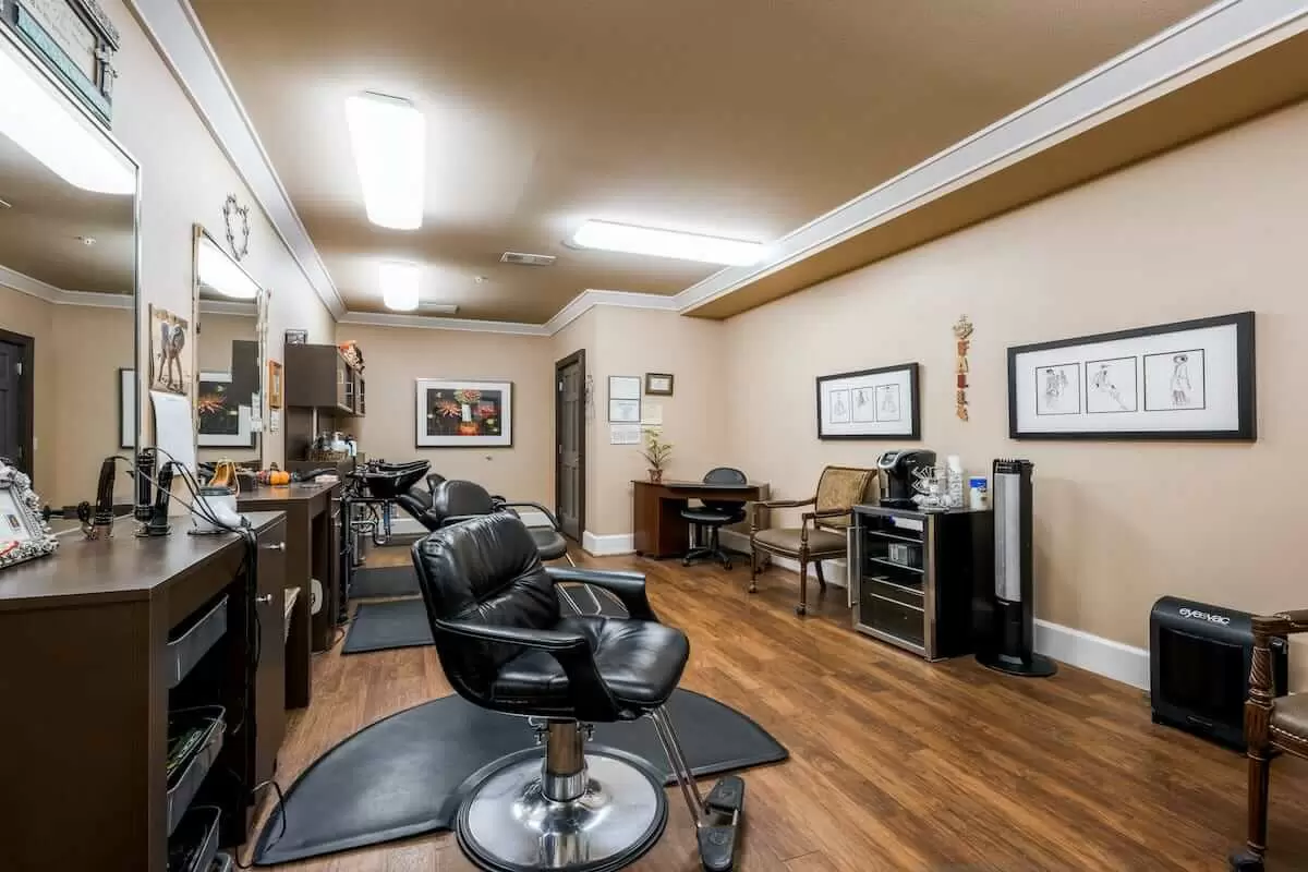 A cozy barber shop with multiple chairs and mirrors, showcasing a neatly arranged interior.