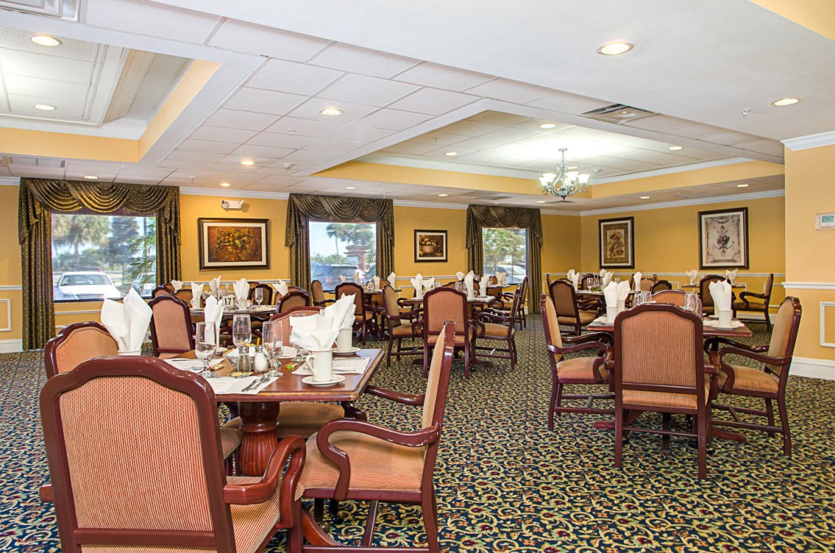 An elegant dining area with neatly arranged tables and chairs, showcasing a welcoming restaurant interior.