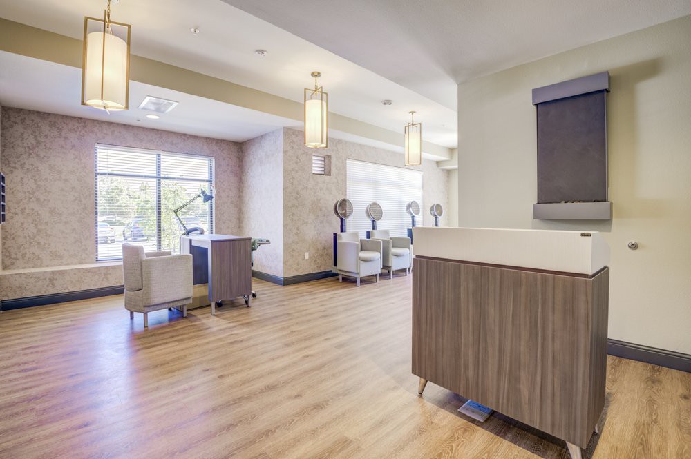 A modern salon interior featuring stylish chairs and contemporary lighting.