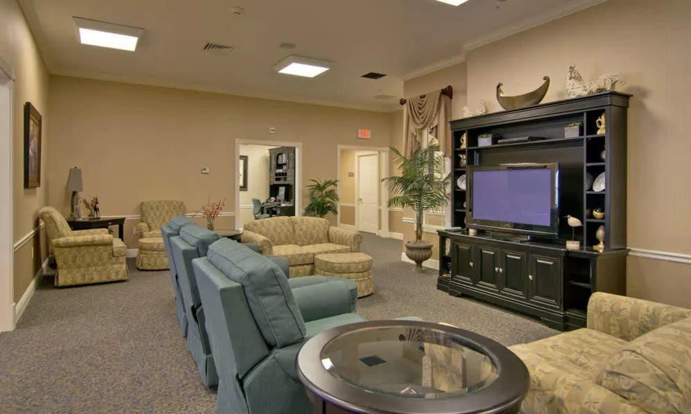 A spacious living room with comfortable seating and a large TV.