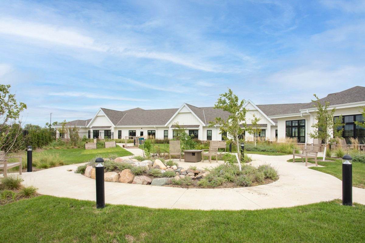 A picturesque building surrounded by a landscaped garden with pathways.