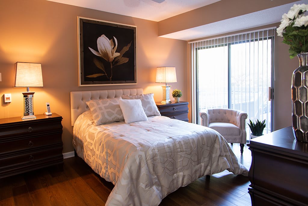A cozy bedroom with a comfortable bed, elegant decor, and warm lighting.