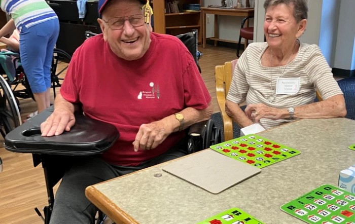 Seniors enjoying a game of bingo together in a community setting.