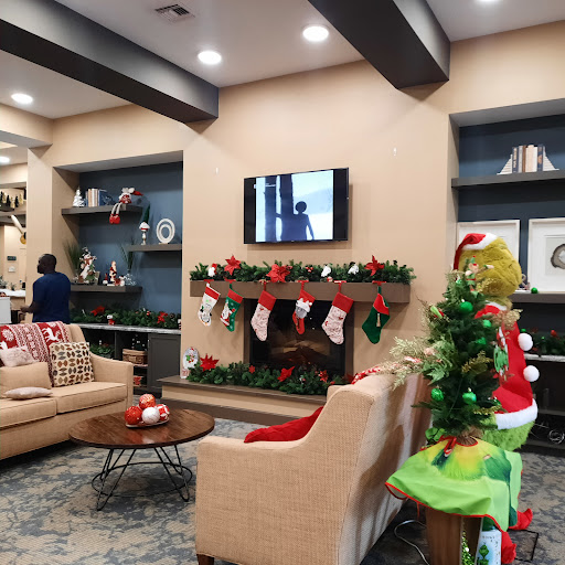 A beautifully decorated living room ready for the holiday season, featuring a cozy seating area and festive Christmas decor.