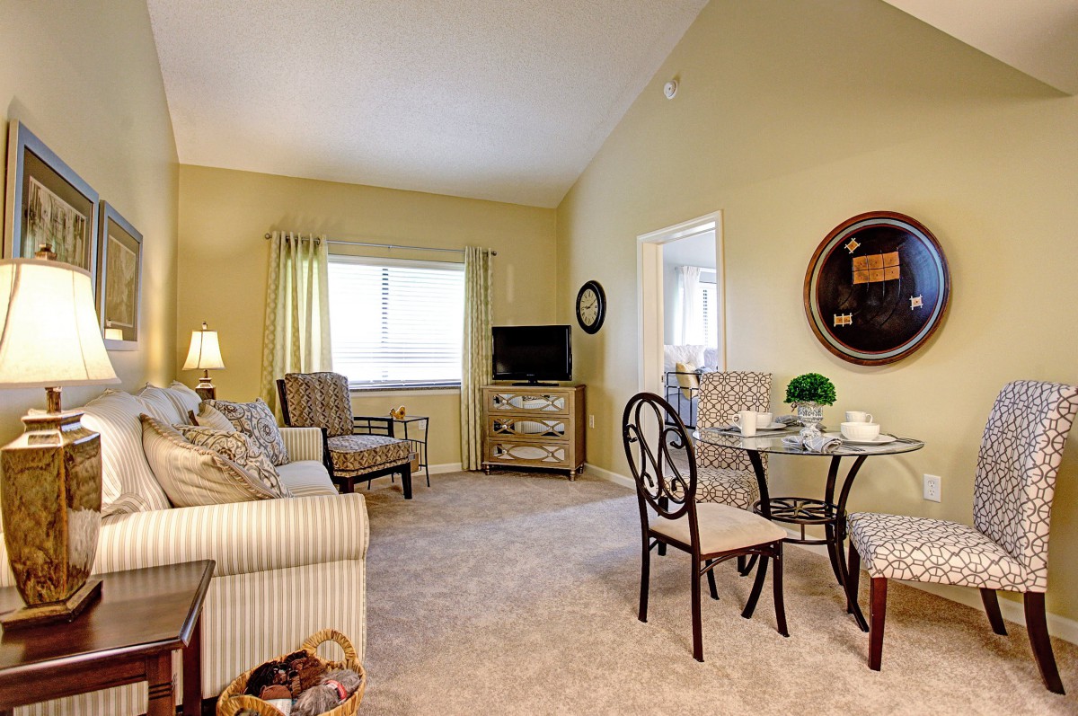 A cozy living room with comfortable seating and a small dining area.