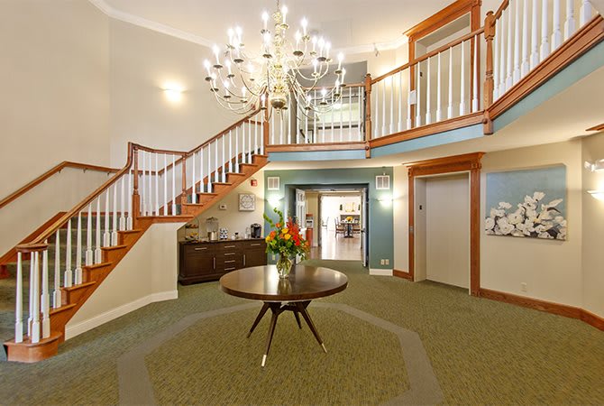 Elegant foyer with a grand staircase and chandelier.