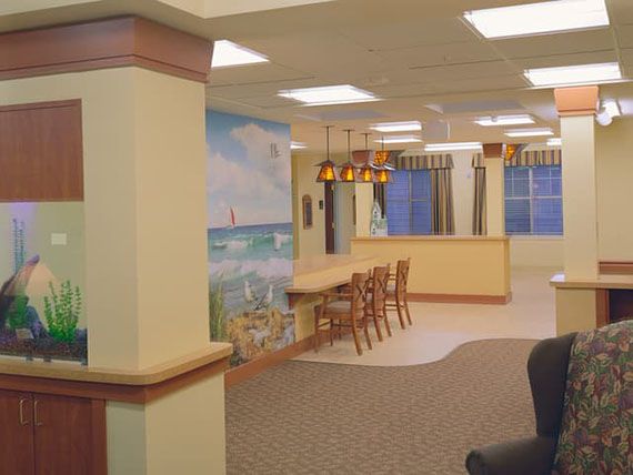 A spacious interior with bar stools, decorative lighting, and a wall mural.