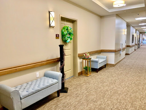 A well-lit and inviting hallway featuring plush benches and decorative elements.