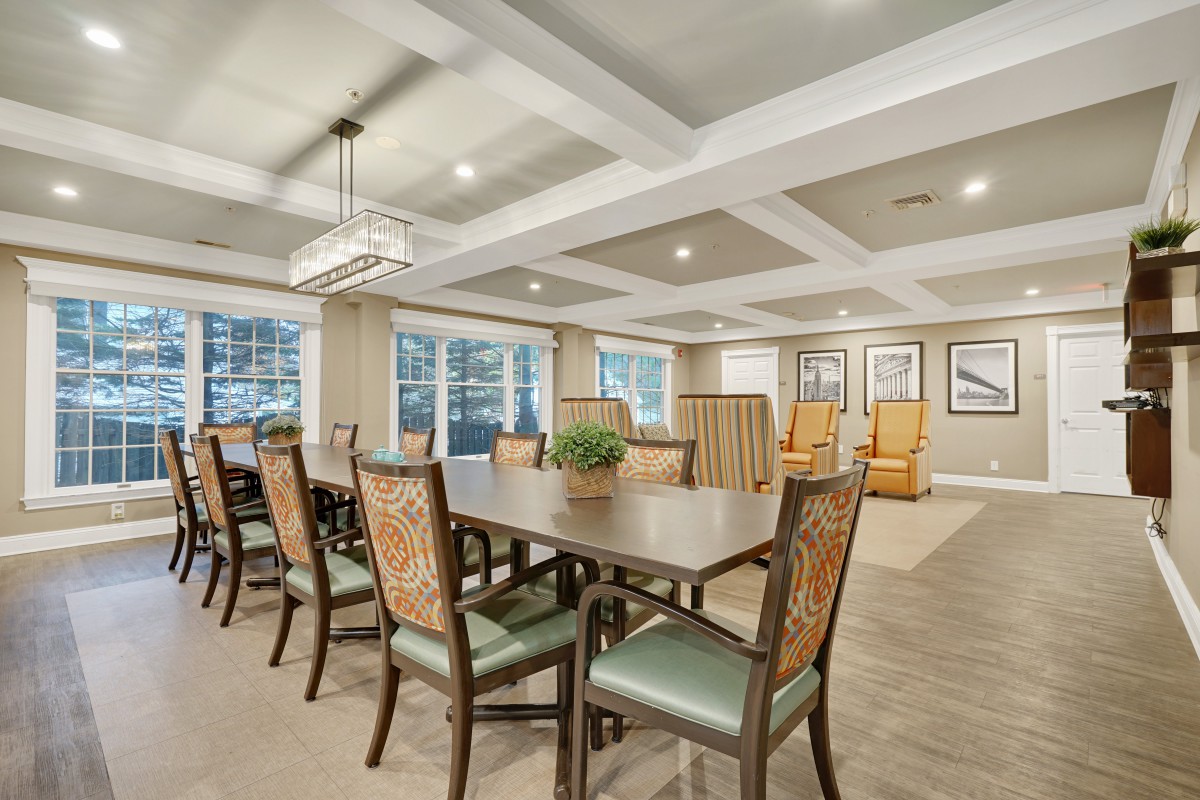 A spacious dining room with elegant furnishings and ample natural light.