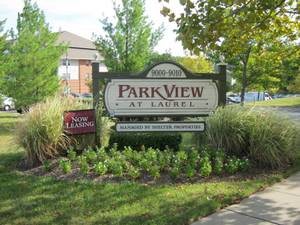 Entrance sign for ParkView at Laurel surrounded by greenery.