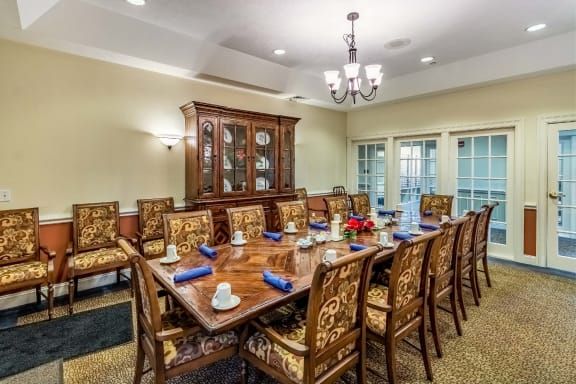 Elegant dining room with a large table and ornate chairs.
