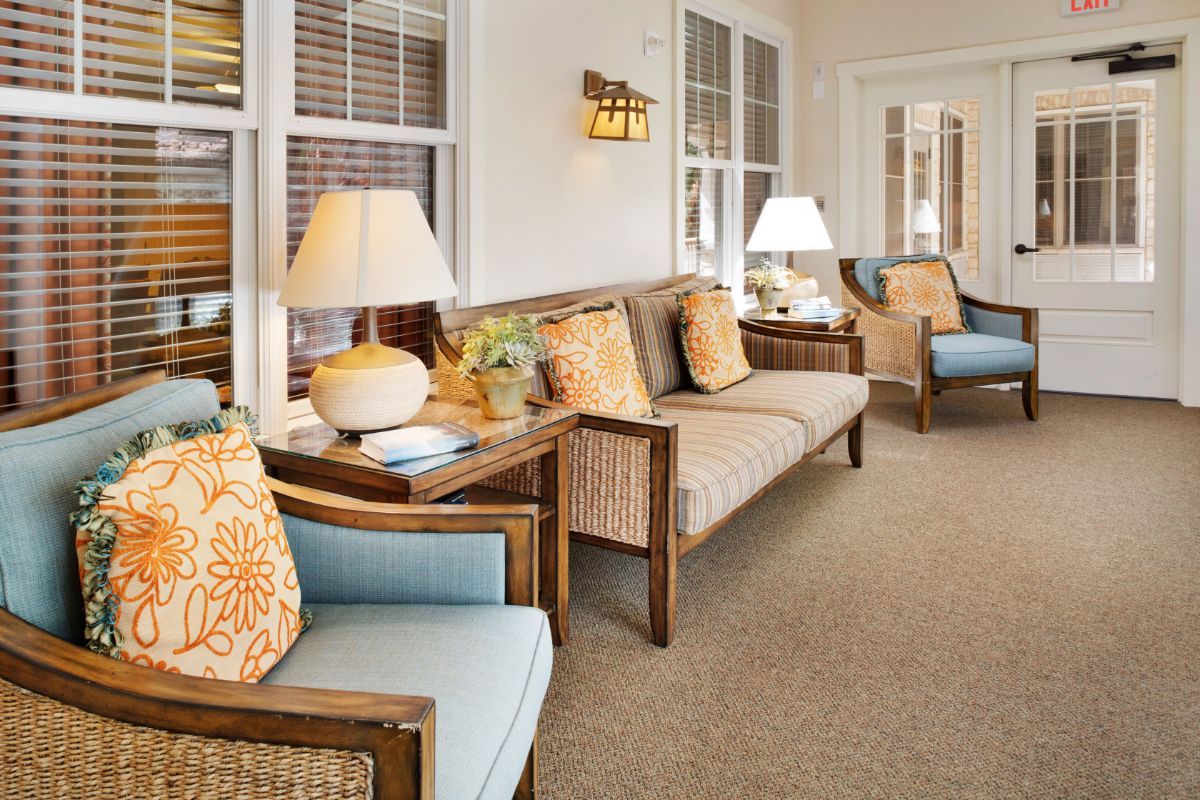 A cozy living room with comfortable seating, decorative cushions, and warm lighting.