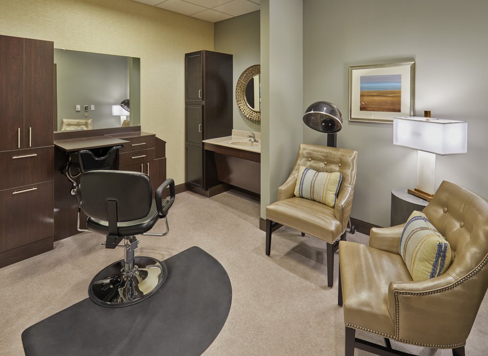 A cozy salon interior with a hairdressing station and comfortable seating.