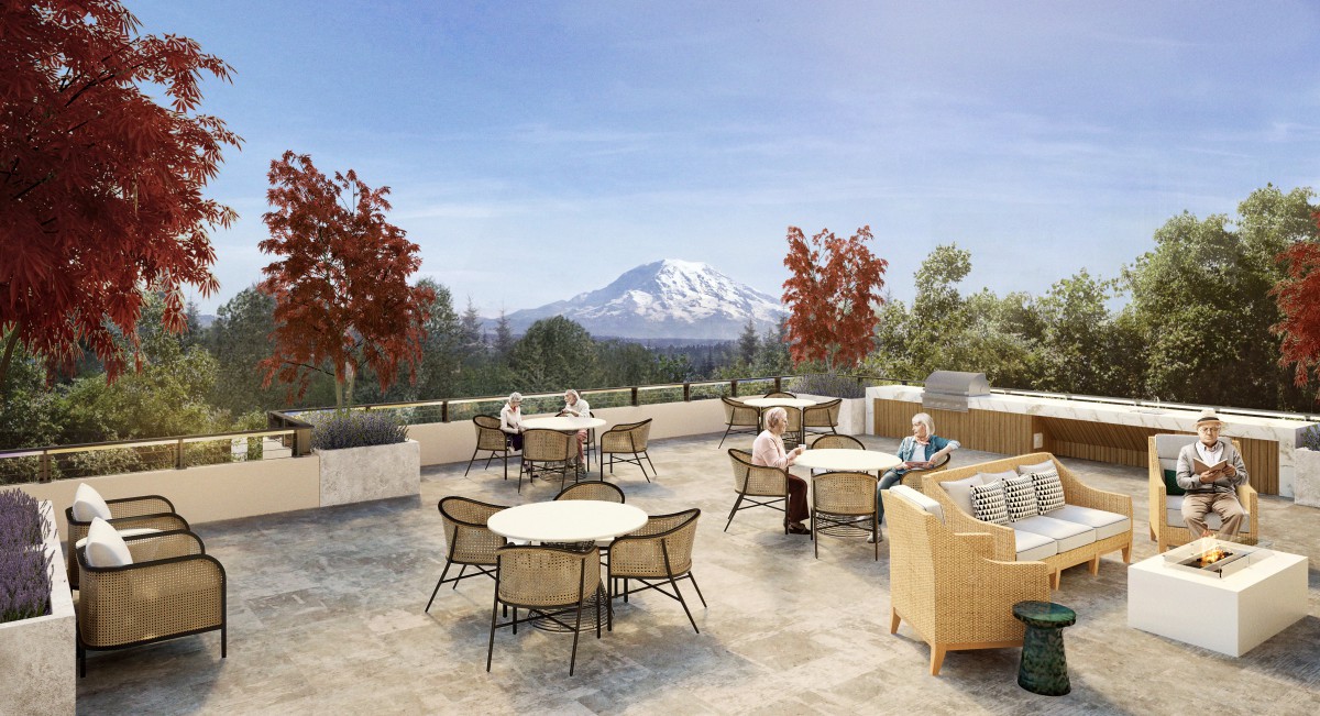 A scenic outdoor patio with tables and chairs, offering a stunning mountain view on a sunny autumn day.