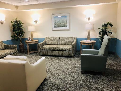 A cozy lounge area featuring comfortable seating and soft lighting.