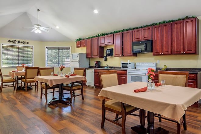 A cozy kitchen and dining area with wooden flooring and modern appliances.