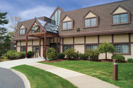 A modern building with a welcoming entrance and landscaped surroundings.