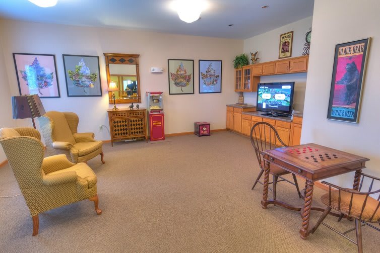 A cozy living room with comfortable seating, a small TV, and decorative elements.