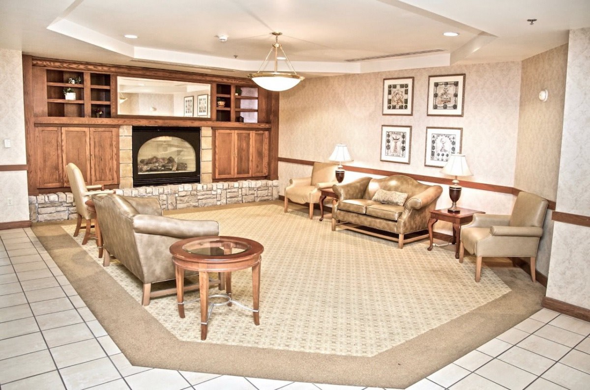 Cozy lounge area with elegant furnishings and a fireplace.