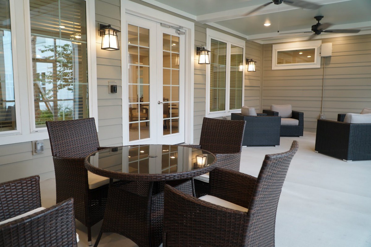A cozy patio with wicker furniture and soft lighting, perfect for relaxing evenings.